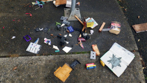 A photograph of a lot of personal items scattered about as if in a disaster, with the Self Help Radio logo superimposed on one of them.